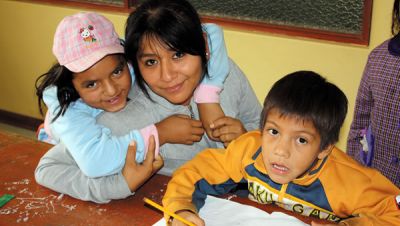 A volunteer works with children and the center