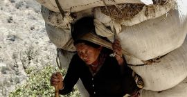 Woman carrying a heavy load